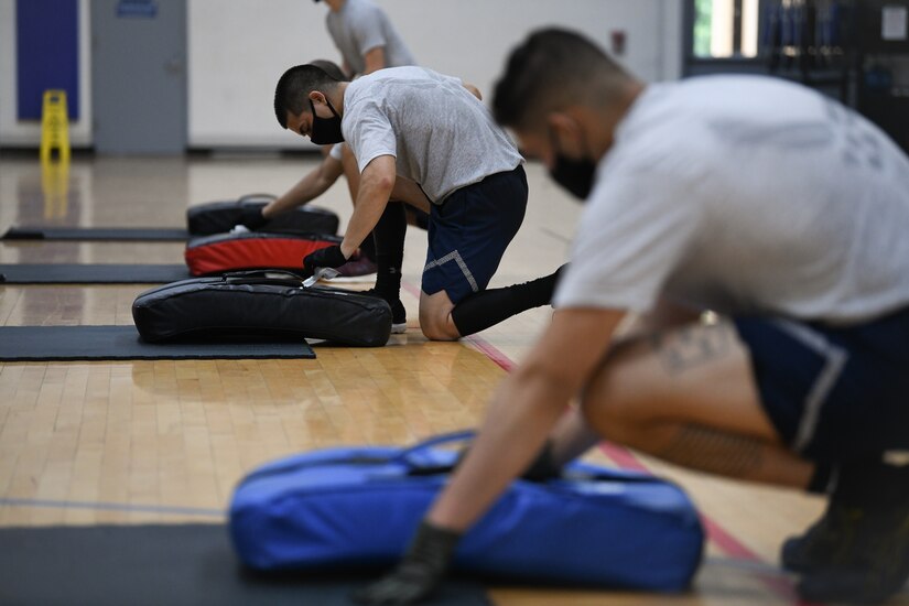 Airmen sanitize their protective equipment during the Fly-Away Security Team training course, nicknamed “Pre-Raven,” at Joint Base Andrews, Md., Aug. 14, 2020.
