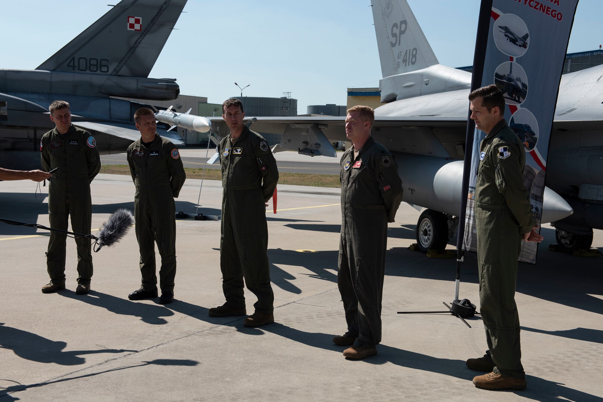 Starting far left, Polish Air Force Col. Tomasz Jatczak, 32nd Tactical Air Base commander, Brig. Gen. Iteneusz Nowak, 2nd Tactical Air Wing commander, U.S. Air Force Col. David Epperson, 52nd Fighter Wing commander, Lt. Col. Patrick Kennedy, 480th Expeditionary Fighter Squadron commander, and Lt. Col. Albert Roper, 52nd Operations Group Detachment One commander, stand in front of a static display for brief interviews at Łask AB, Poland, August 21, 2020. By meeting together, leadership from the Polish and U.S. forces participating in the ongoing Aviation Detachment Rotation were able to exchange perspectives, develop friendships, and enhance the partnership between the two countries. (U.S. Air Force photo by Senior Airman Melody W. Howley)