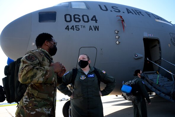 Reserve Citizen Airmen, Tech. Sgt. Ian Warrior and Master Sgt. Brandi Seibel, both 932nd Aeromedical Evacuation Squadron (AES) technicians, chat about the training plan before loading gear on a C-17 Globemaster, August 22, 2020, at Scott Air Force Base, Ill.  The training opportunity on the aircraft was provided by the 445th Airlift Wing, an Air Force Reserve unit visiting from Wright Patterson Air Force Base, Ohio. Training featured interaction between medical personnel and loadmasters, working together on care of equipment, reacting to potential scenarios and care of patients aboard the aircraft, simulating a deployed environment.  (U.S. Air Force photos by Lt. Col. Stan Paregien)