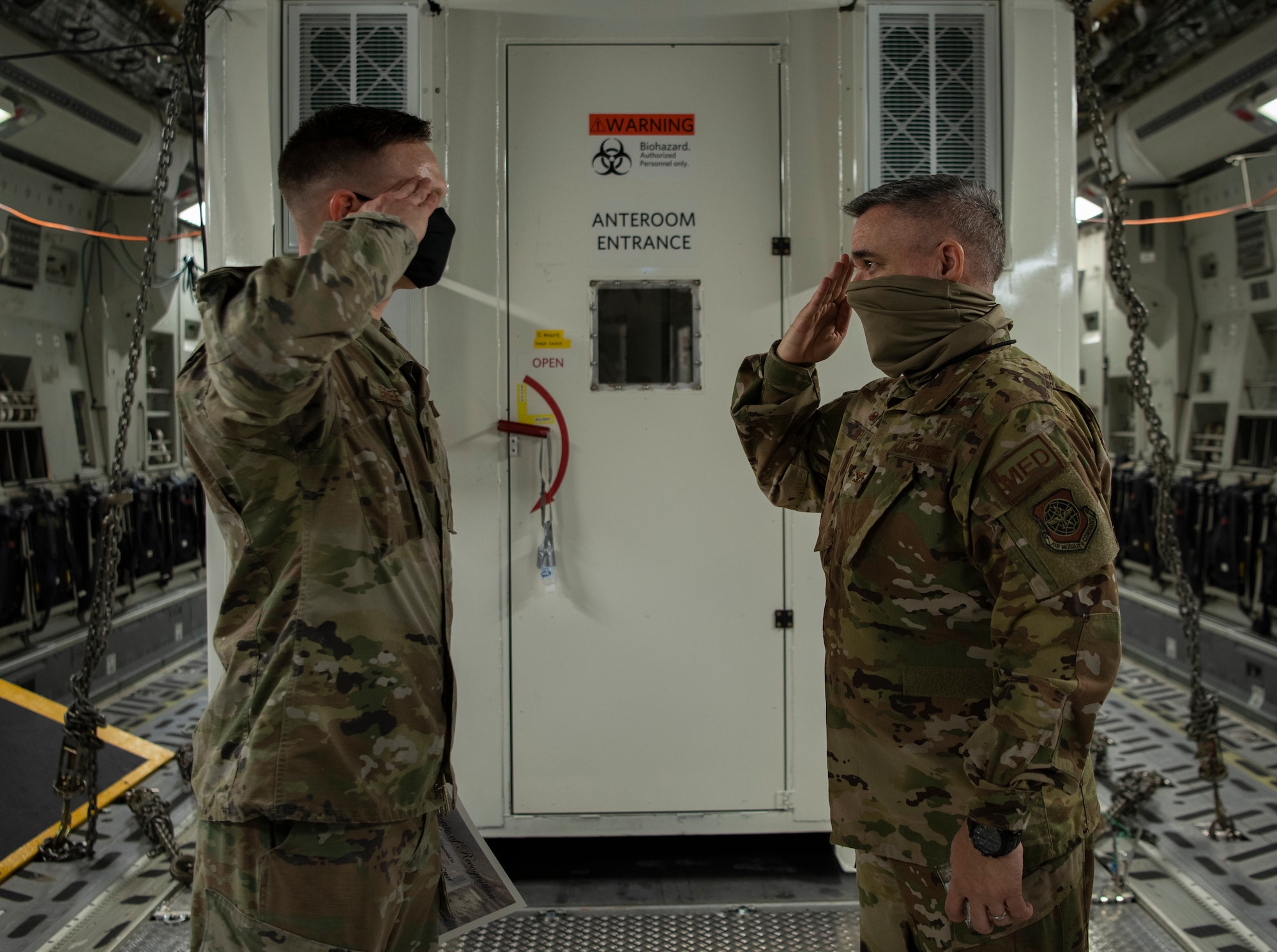 U.S. Air Force Senior Airman Dyllan Greer, 786th Civil Engineer Squadron structural journeyman, salutes Col. Matthew Hendell, 934th Aeromedical Evacuation Squadron commander, at Ramstein Air Base, Germany, Aug. 19, 2020.