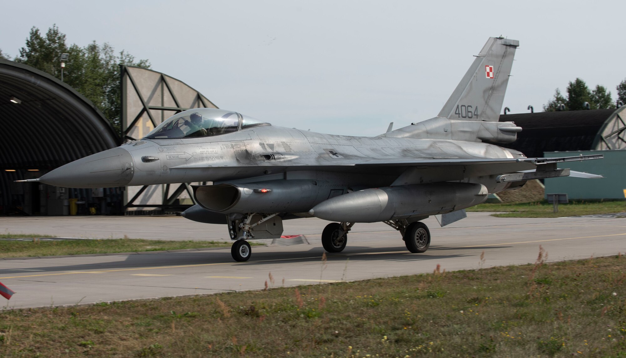 A Polish air force F-16, assigned to the 32nd Tactical Air Base, taxis out of a hangar at Łask AB, Poland, August 19, 2020. The U.S. and Polish forces integrated to participate in Aviation Detachment Rotation 20.4, with goals to progress partnerships, strengthen capabilities and learn from each other. (U.S. Air Force photo by Senior Airman Melody W. Howley)