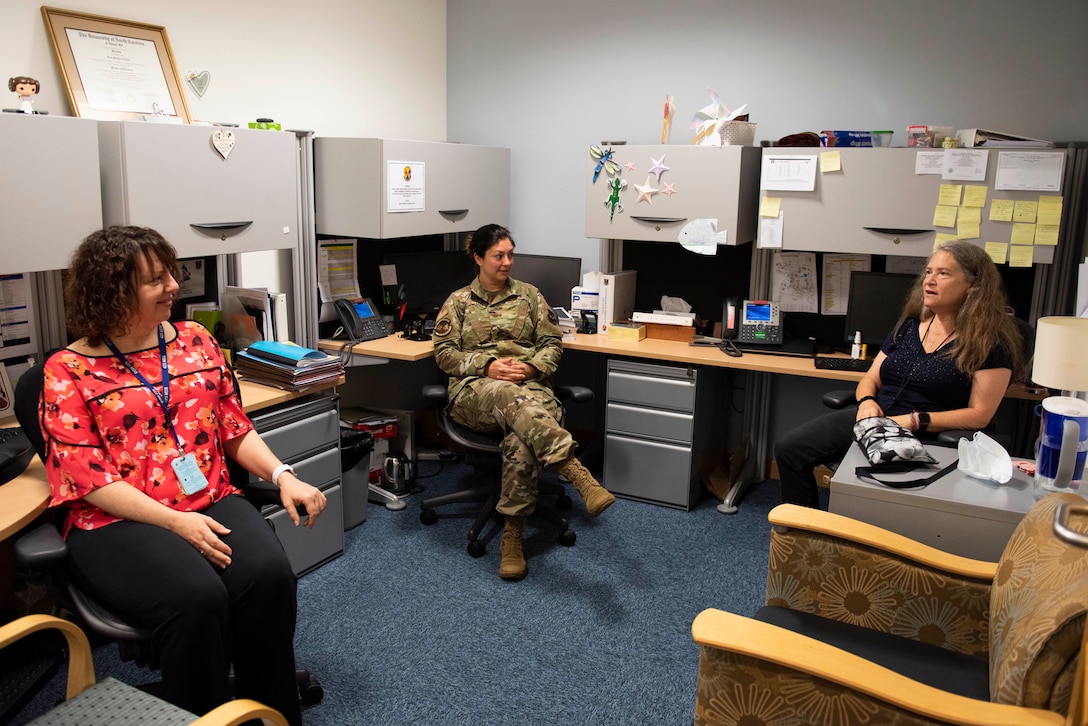 Gail Slaughter (right), 423rd Medical Squadron pediatric occupational therapist, talks with her coworkers, Lisa Clifton (left), 423rd MDS early childhood special educator, and Maj. Darnell Schuettler (center), 423rd MDS Educational and Developmental Intervention Services (EDIS) program manager and mental health flight commander, about working with EDIS families at RAF Alconbury, England, Aug. 20, 2020. The EDIS program provides support to children who have developmental or special educational needs in their homes or classrooms. (U.S. Air Force photo by Airman 1st Class Jennifer Zima).