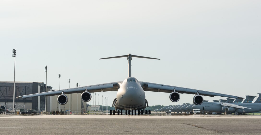 A C-5M Super Galaxy taxis down the flight line prior to an early evening takeoff Aug. 21, 2020, at Dover Air Force Base, Delaware. Eighteen C-5M’s are assigned to Dover AFB, along with 13 C-17 Globemaster IIIs that provide 20 percent of the nation’s outsized airlift capacity. (U.S. Air Force photo by Roland Balik)