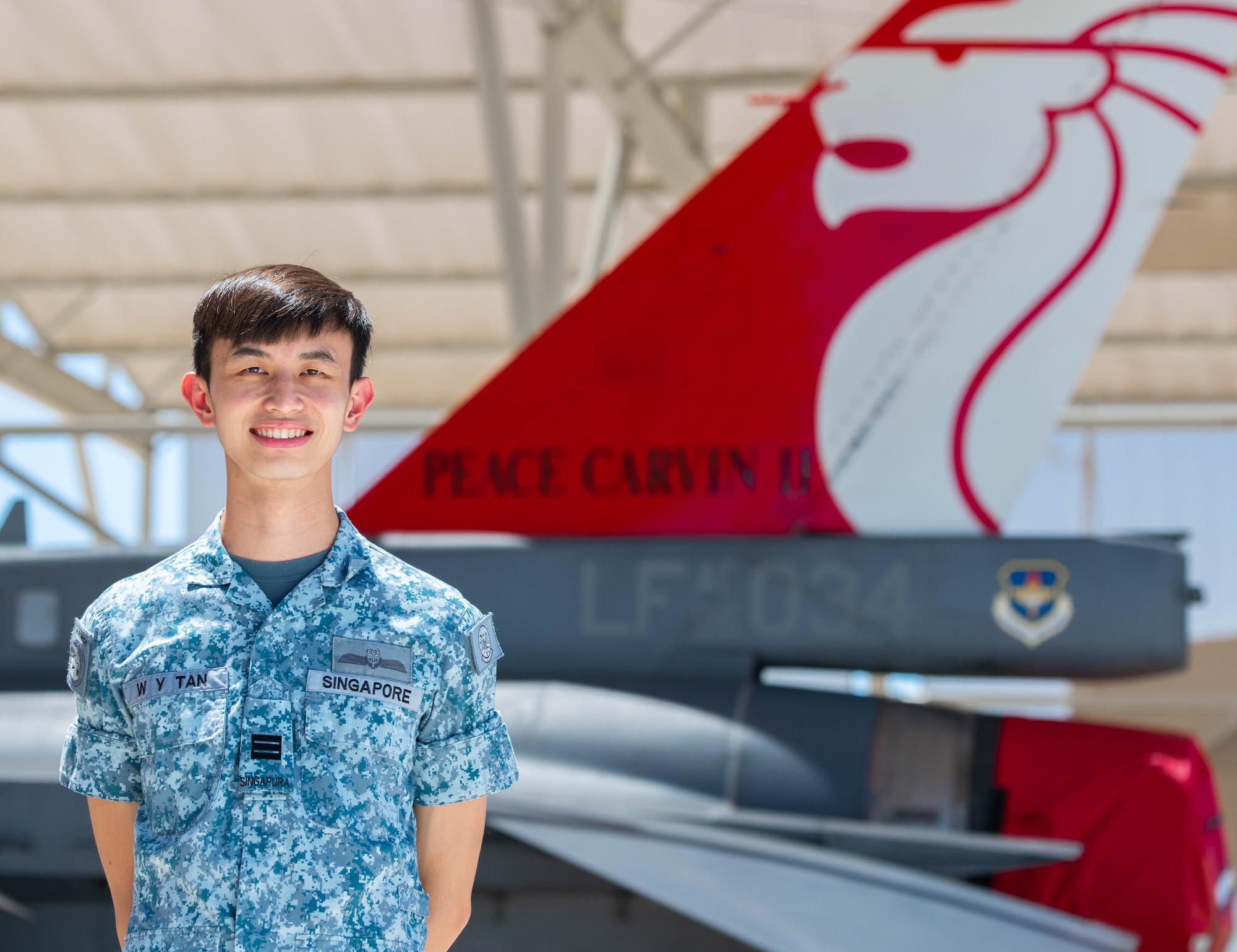 Republic of Singapore Air Force Capt. Tan Wei Yang, 425th Fighter Squadron pilot, stands beside an RSAF F-16D Fighting Falcon, Aug. 5, 2020, at Luke Air Force Base, Ariz.