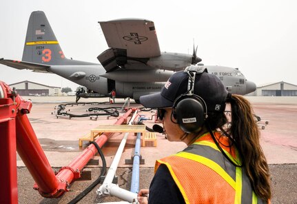 Crews from the 146th Airlift Wing, 153rd Airlift Wing, CAL FIRE, the U.S. Forest Service and other government and civilian agencies work together at McClellan Air Park, California, to refuel and reload fire retardant to aircraft from around the nation battling the wildfires across California Aug. 21, 2020.