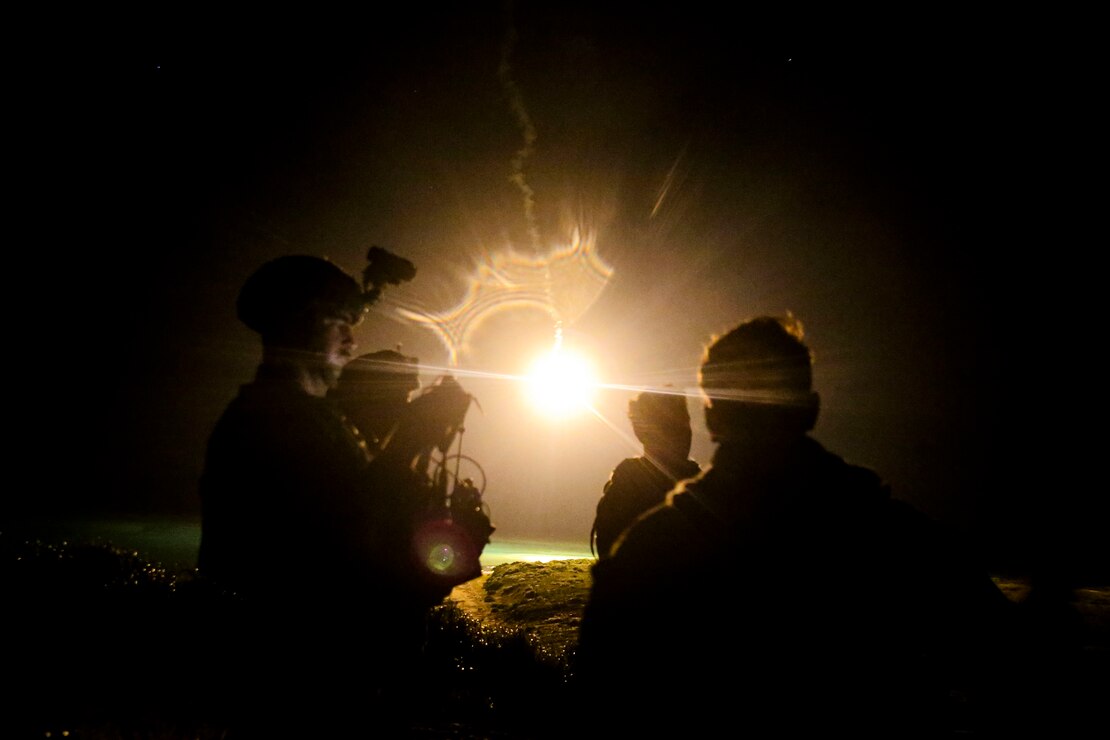 U.S. Marines watch illuminating rounds during a simulated close air support and assault support training event at W-174, Okinawa, Japan, Aug. 18.