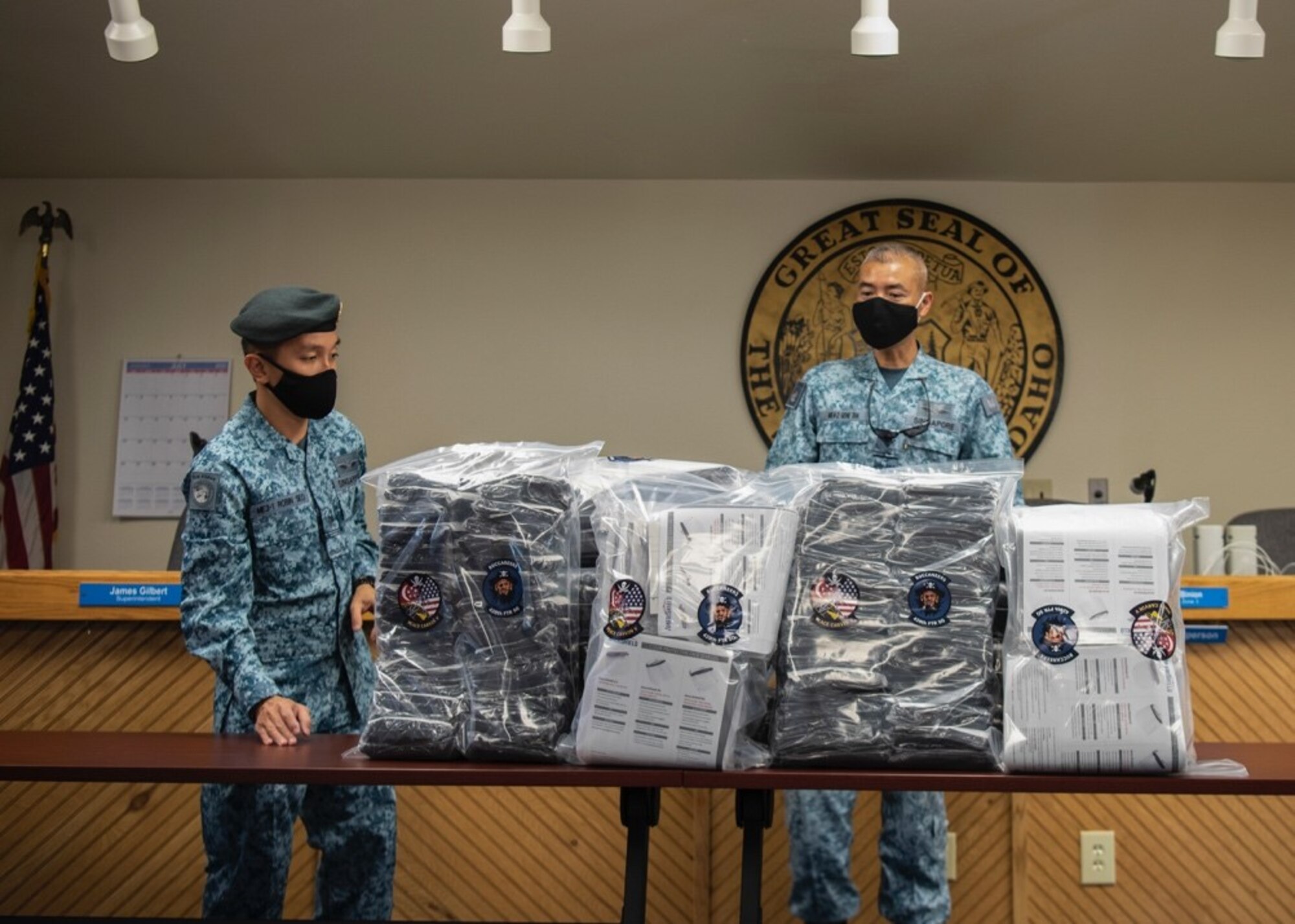 Royal Singaporean Air Force ME3 Robin Seo, 428th Fighter Squadron air force engineer, and RSAF ME4 Gene Tan, 428th FS command chief, prepare 2,000 face coverings for reception at the Mountain Home School District Office, Aug. 6, 2020, in Mountain Home, Idaho. The 428th FS also donated 180 face shields to help aid the MHSD’s battle against COVID-19. (U.S. Air Force photo by Airman 1st Class Gary Hilton)