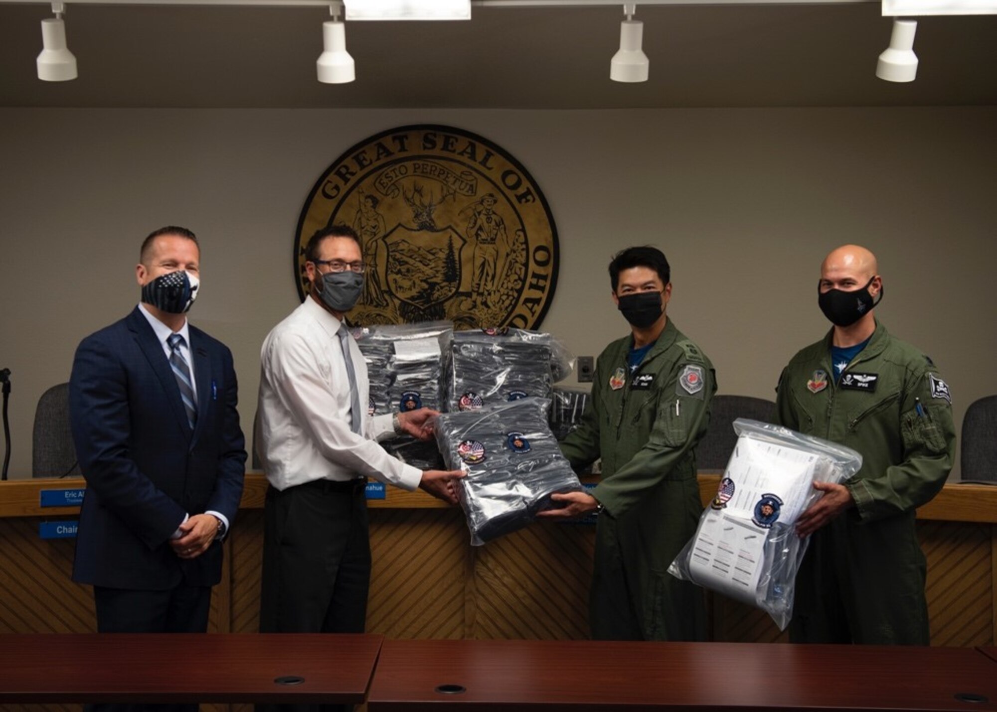 (From left to right) Rich Sykes, the mayor of Mountain Home, Mr. James Gilbert, Mountain Home School District Superintendent, Royal Singaporean Air Force Lt. Col. Shewan Goh, 428th Fighter Squadron senior ranking officer, and U.S. Air Force Lt. Col. Nicholas Jurewicz, 428th Fighter Squadron commander, pose with a package of donated face coverings at the Mountain Home School District Office, Aug. 6, 2020, in Mountain Home, Idaho. The 428th FS distributed 2,000 face coverings and 180 face shields to aid the MHSD’s battle against COVID-19. (U.S. Air Force photo by Airman 1st Class Gary Hilton)