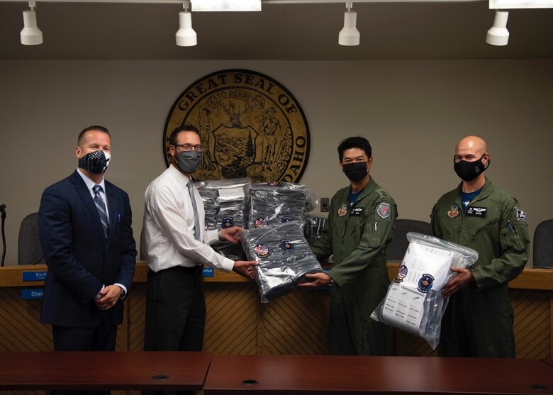 (From left to right) Rich Sykes, the mayor of Mountain Home, Mr. James Gilbert, Mountain Home School District Superintendent, Royal Singaporean Air Force Lt. Col. Shewan Goh, 428th Fighter Squadron senior ranking officer, and U.S. Air Force Lt. Col. Nicholas Jurewicz, 428th Fighter Squadron commander, pose with a package of donated face coverings at the Mountain Home School District Office, Aug. 6, 2020, in Mountain Home, Idaho. The 428th FS distributed 2,000 face coverings and 180 face shields to aid the MHSD’s battle against COVID-19. (U.S. Air Force photo by Airman 1st Class Gary Hilton)