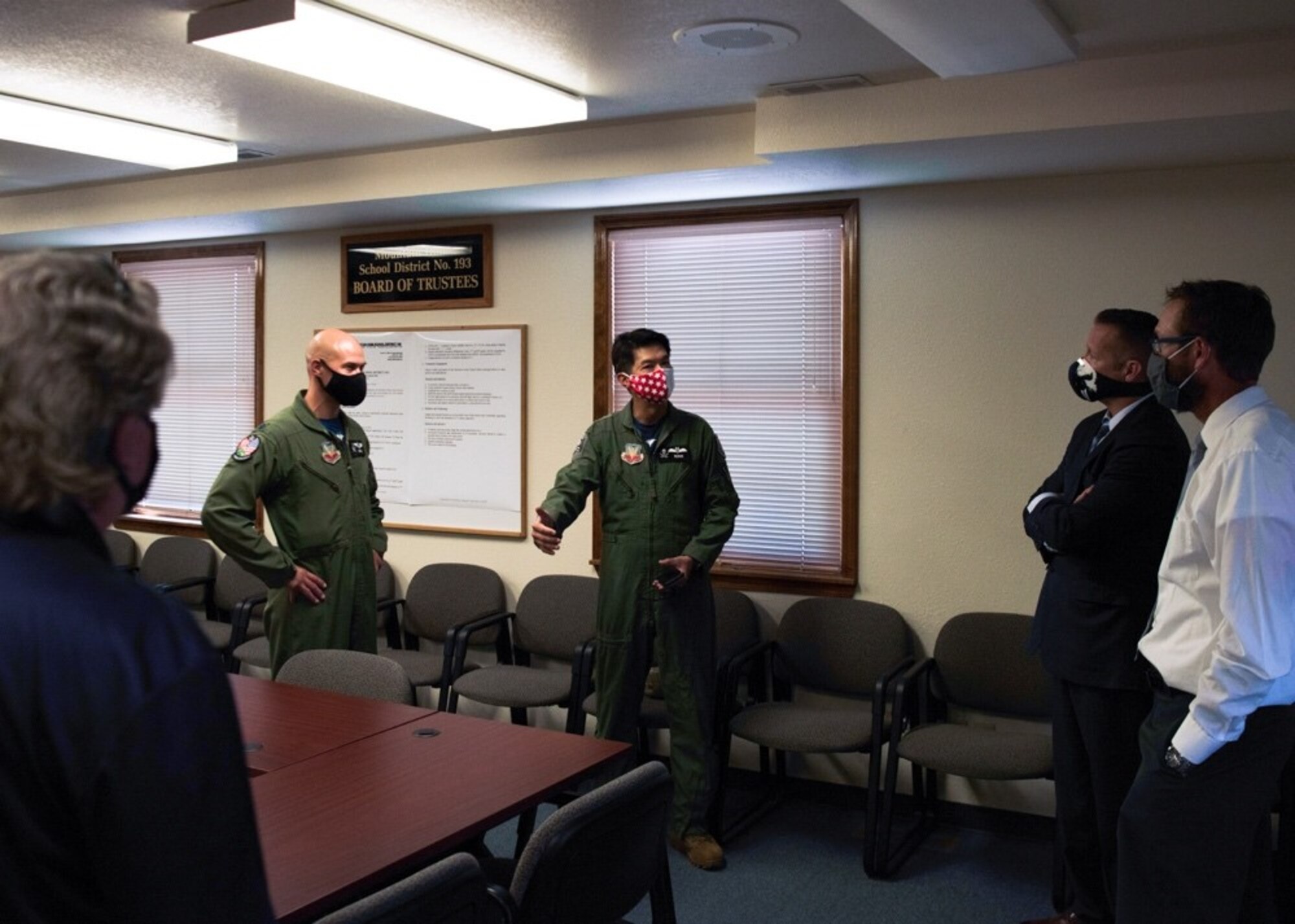 Royal Singaporean Air Force Lt. Col. Shewan Goh, 428th Fighter Squadron senior ranking officer, and U.S. Air Force Lt. Col. Nicholas Jurewicz, 428th FS commander, council with Rich Sykes, the mayor of Mountain Home, and Mountain Home School District liasons, at the Mountain Home School District Office, Aug. 6, 2020, in Mountain Home, Idaho. The 428th FS distributed 2,000 face coverings and 180 face shields to help aid the MHSD’s battle against COVID-19. (U.S. Air Force photo by Airman 1st Class Gary Hilton)