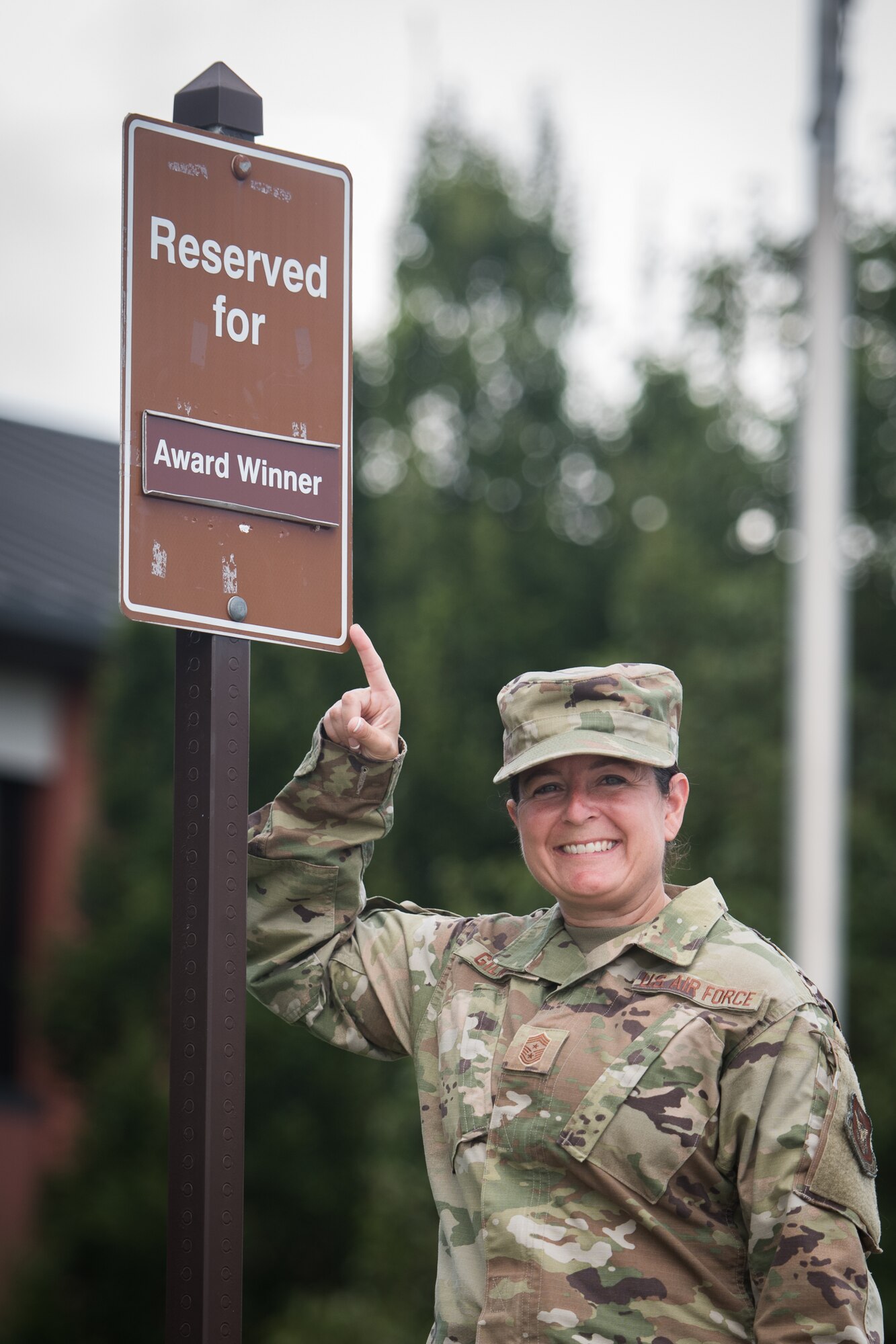 Chief Master Sgt. Barbara Gilmore, command chief, 932nd Airlift Wing, showcases the new allocated parking spot located in the front of the 932nd AW Headquarters building, Aug. 18, 2020, Scott Air Force Base, Illinois.  932nd AW Annual and Quarterly award winners now can compete in a first-come competition for front row prime parking spot during weekdays and unit training assembly (UTA) weekends. “With parking sometimes limited during a UTA weekend, I wanted to find a way to honor our award winners for prime parking, said Gilmore about the importance of creating the parking spot for award winners. (U.S. Air Force photo by Christopher Parr)