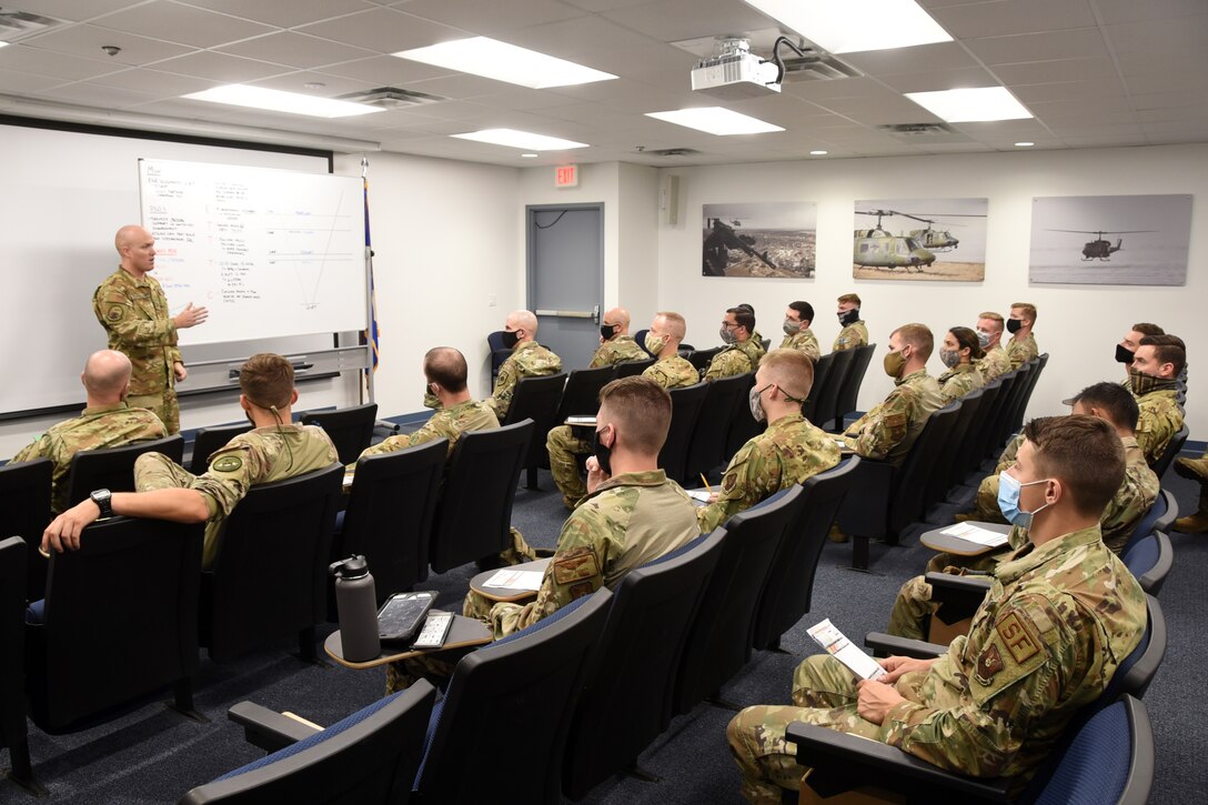 Airmen in a briefing room.
