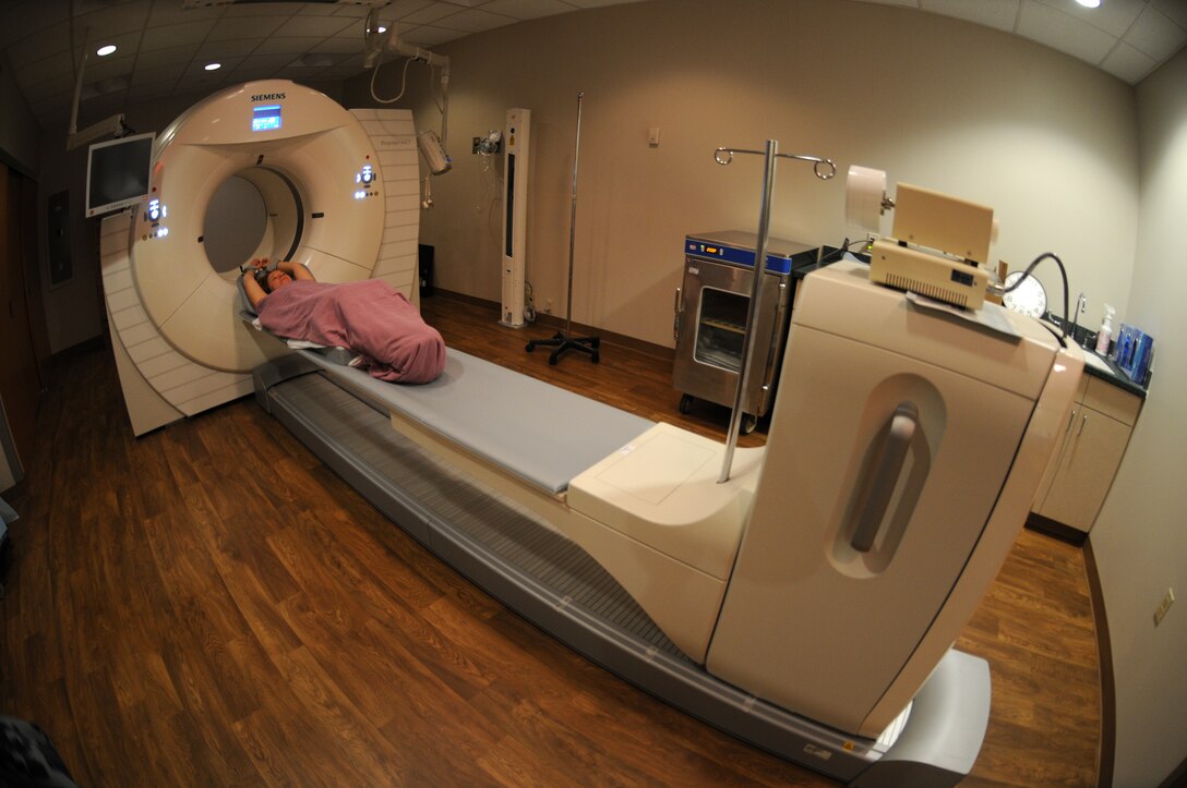 A patient lies on her back and ready to receive a CT scan.