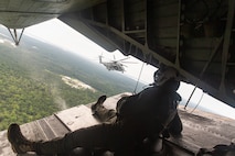 Cpl. Justin Gowan, a crew chief with Marine Heavy Helicopter Squadron 366, observes a CH-53E Super Stallion during Exercise Deep Water 2020 at Marine Corps Air Station, New River, North Carolina, July, 29, 2020. The purpose of the exercise is to increase 2nd Marine Aircraft Wing’s interoperability and readiness on a scale that simulates peer-level threats. (U.S. Marine Corps photo by Lance Cpl. Yuritzy Gomez)
