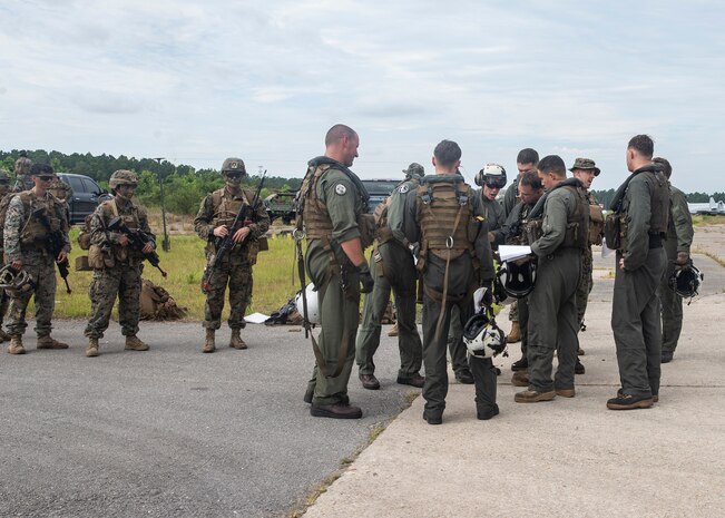 Marines with Marine Heavy Helicopter Squadron 366 and 3rd Battalion, 6th Marine Regiment, prepare to board a CH-53E Super Stallion during Exercise Deep Water 2020 at Marine Corps Air Station New River, North Carolina, July 29, 2020. The purpose of the exercise is to increase 2nd Marine Aircraft Wing’s interoperability and readiness on a scale that simulates peer-level threats. (U.S. Marine Corps photo by Lance Cpl. Yuritzy Gomez)