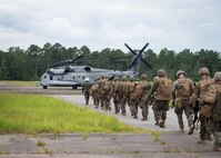 Marines with 3rd Battalion, 6th Marine Regiment prepare to board a CH-53E Super Stallion with Marine Heavy Helicopter Squadron 366 during Exercise Deep Water 2020 at Marine Corps Air Station New River, North Carolina, July 29, 2020. The purpose of the exercise is to increase 2nd Marine Aircraft Wing’s interoperability and readiness on a scale that simulates peer-level threats. (U.S. Marine Corps photo by Lance Cpl. Yuritzy Gomez)