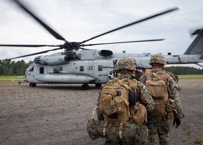Marines with 3rd Battalion, 6th Marines, board a CH-53E Super Stallion with Marine Heavy Helicopter Squadron 366 during Exercise Deep Water 2020 at Marine Corps Air Station New River, North Carolina, July 29, 2020. The purpose of the exercise is to increase 2nd Marine Aircraft Wing’s interoperability and readiness on a scale that simulates peer-level threats. (U.S. Marine Corps photo by Lance Cpl. Yuritzy Gomez)
