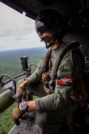 Gunnery Sgt. Corey M. Butts, a crew chief with Marine Light Attack Helicopter Squadron 167, looks out the side of a UH-1Y Huey during Exercise Deep Water 2020 at Marine Corps Air Station New River, North Carolina, July 29, 2020. The purpose of the exercise is to increase 2nd Marine Aircraft Wing’s interoperability and readiness on a scale that simulates peer-level threats. (U.S. Marine Corps photo by Lance Cpl. Elias E. Pimentel III)