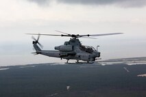 A U.S. Marine Corps AH-1Z Viper with Marine Light Attack Helicopter Squadron 269 conducts reconnaissance and surveillance, during Exercise Deep Water 2020, above Marine Corps Air Station New River, North Carolina, July 29, 2020. The purpose of the exercise is to increase 2nd Marine Aircraft Wing's interoperability and readiness on a scale that simulates peer-level threats. (U.S Marine Corps Photo by Cpl. Juan C. Dominguez)
