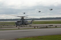 A U.S. Marine Corps AH-1Z Viper with Marine Light Attack Helicopter Squadron 269 and CH-53E Super Stallions with Marine Heavy Helicopter Squadron 366 land during Exercise Deep Water 2020 at Marine Corps Air Station New River, North Carolina, July 29, 2020. The purpose of the exercise is to increase 2nd Marine Aircraft Wing's interoperability and readiness on a scale that simulates peer-level threats. (U.S Marine Corps Photo by Cpl. Juan C. Dominguez)