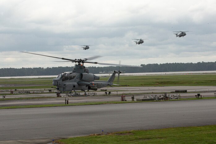 A U.S. Marine Corps AH-1Z Viper with Marine Light Attack Helicopter Squadron 269 and CH-53E Super Stallions with Marine Heavy Helicopter Squadron 366 land during Exercise Deep Water 2020 at Marine Corps Air Station New River, North Carolina, July 29, 2020. The purpose of the exercise is to increase 2nd Marine Aircraft Wing's interoperability and readiness on a scale that simulates peer-level threats. (U.S Marine Corps Photo by Cpl. Juan C. Dominguez)
