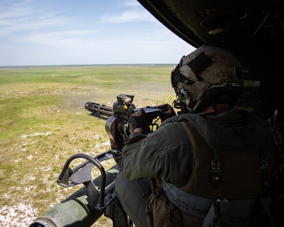 Sgt. Nicholas Prince, a crew chief with Marine Light Attack Helicopter Squadron 269, fires a GAU-17 Minigun inside a Marine Corps UH-1Y Venom over Marine Corps Base Camp Lejeune, North Carolina, July 31, 2020. HMLA-269 practiced close air support and aerial surveillance to maintain mission readiness. (U.S. Marine Corps photo by Cpl. Cody Rowe)