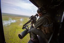 Sgt. Nicholas Prince, a crew chief with Marine Light Attack Helicopter Squadron 269, rides in a Marine Corps UH-1Y Venom over Marine Corps Base Camp Lejeune, North Carolina, July 31, 2020. HMLA-269 practiced close air support and aerial surveillance to maintain mission readiness. (U.S. Marine Corps photo by Cpl. Cody Rowe)