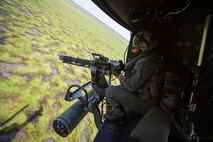 Sgt. Nicholas Prince, a crew chief with Marine Light Attack Helicopter Squadron 269, rides in a Marine Corps UH-1Y Venom over Marine Corps Base Camp Lejeune, North Carolina, July 31, 2020. HMLA-269 practiced close air support and aerial surveillance to maintain mission readiness. (U.S. Marine Corps photo by Cpl. Cody Rowe)