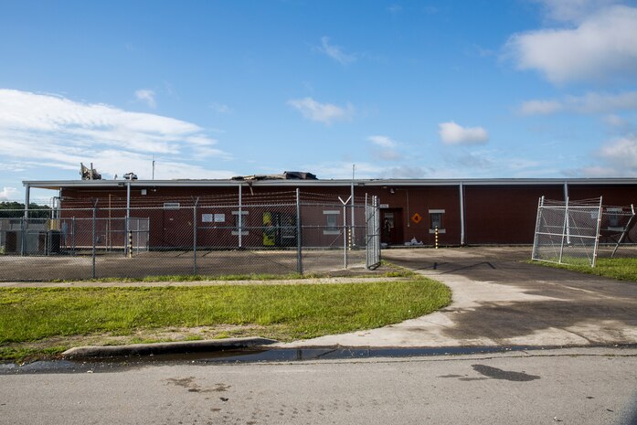 A broken roof protrudes above the School of Infantry-East Armory from Hurricane Isaias' winds at Camp Geiger on Marine Corps Air Station New River, North Carolina, Aug. 4, 2020. U.S. Marines carried out recovery efforts in order to resume normal operations while following COVID-19 mitigation guidelines. (U.S. Marine Corps Photo by Lance Cpl. Christian Ayers)