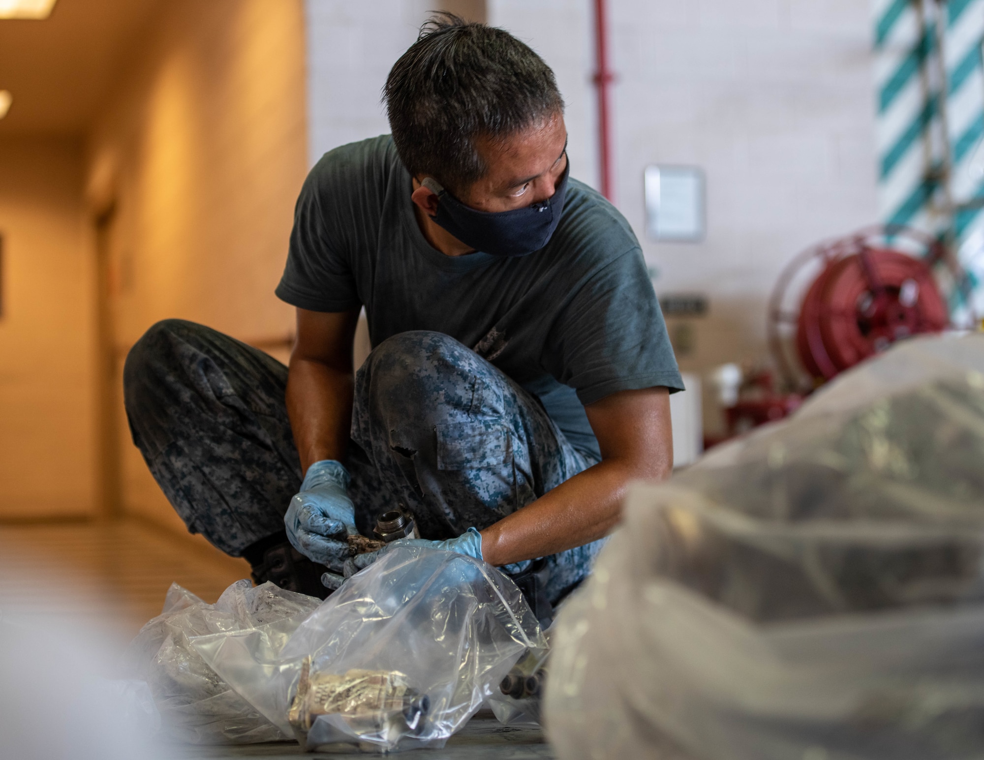 Republic of Singapore Air Force Military Expert Two Second Warrant Officer Kong Kum Cheong, 425th Fighter Squadron maintainer, gathers aircraft parts Aug. 5, 2020, at Luke Air Force Base, Ariz.