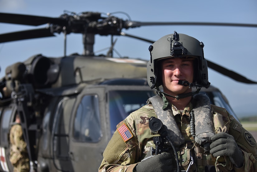U.S. Army Lt. Ian Gidcomb, a pilot assigned to the 1st Battalion 228th Aviation Regiment Air Ambulance Detachment at Joint Task Force-Bravo, stands in front of a UH-60 Blackhawk at Soto Cano Air Base, Honduras July 31, 2020. Gidcomb served as a co-pilot in the third aeromedical evacuation mission.