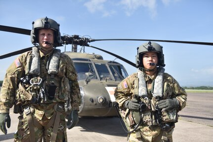 U.S. Army Capt. Richard Jackson (left), a flight doctor assigned to the 1st Battalion 228th Aviation Regiment Air Ambulance Detachment at Joint Task Force-Bravo, and U.S. Army Staff Sgt. Steven Thai (right), a flight medic assigned to the 1st Battalion 228th Aviation Regiment Air Ambulance Detachment at Joint Task Force-Bravo, poses in front of a UH-60 Blackhawk  at Soto Cano Air Base, Honduras July 31, 2020. Jackson and Thai are two members of the crew who provided lifesaving medical care during a Jul.14 mission. The 1-228 Charlie Company is comprised of just 20 members and is the only aeromedical evacuation in the U.S. Southern Command area of responsibility.