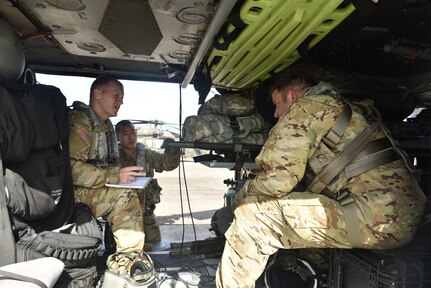 U.S. Army aircrew, assigned to the 1st Battalion 228th Aviation Regiment Air Ambulance Detachment at Joint Task Force-Bravo, discuss possible injury scenarios and associated medical responses to given injuries during a medical evacuation training exercise at Soto Cano Air Base, Honduras July 31, 2020. 1-228 medics prepositioned COVID-kits to battle the pandemic.