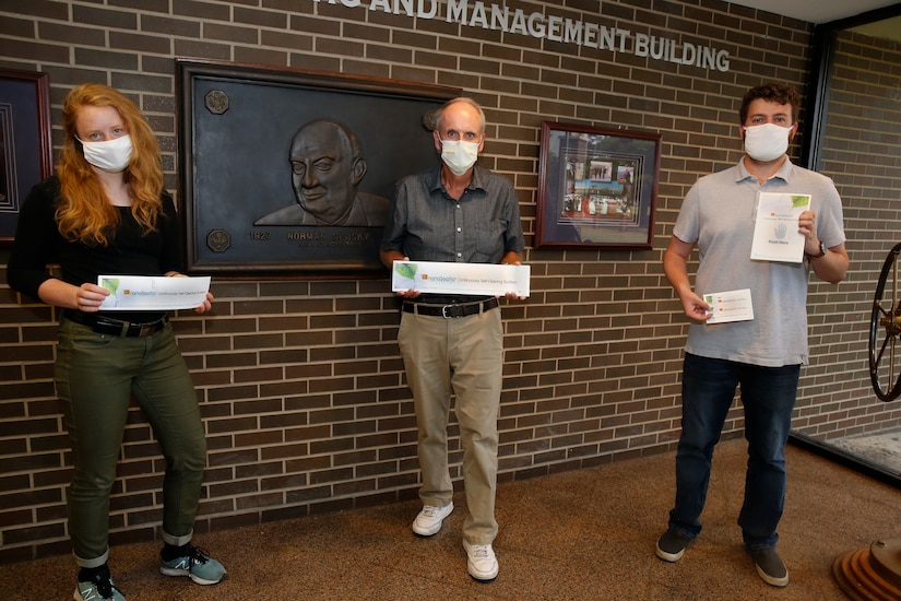 Engineers pose with NanoSeptic sheets.