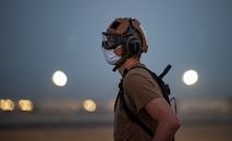 Sailor stands on the flight line.