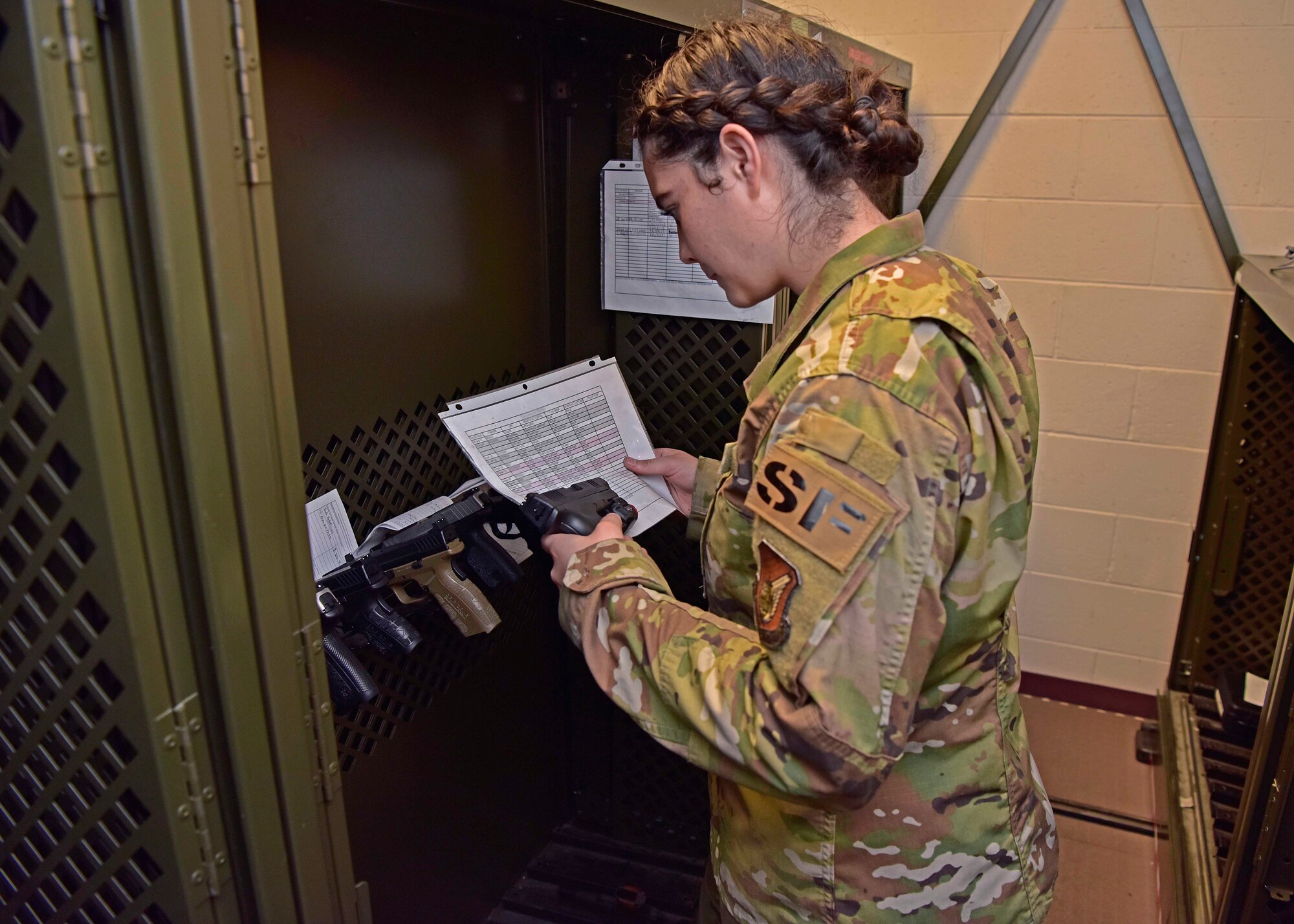 U.S. Air Force Airman 1st Class Sadie Rojas, a 354th Security Forces Squadron armorer, verifies a serial number on a personally-owned firearm on Eielson Air Force Base, Alaska, Aug. 21, 2020. All Eielson residents must register their firearms with the 354th SFS for accountability purposes. This photo has been altered for operational security purposes. (U.S. Air Force photo by Senior Airman Beaux Hebert)