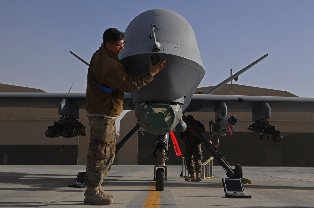 U.S. Air Force Airman 1st Class Eric Rosales, 62nd Attack Squadron crew chiefs, works on an MQ-9 Reaper on Kandahar Airfield, Afghanistan, Jan. 18, 2018.  (U.S. Air Force photo by Staff Sgt. Sean Martin)