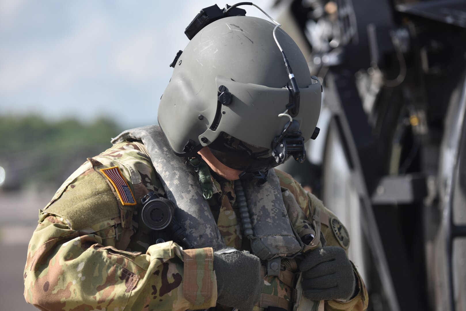 U.S. Army 1st Lt. Ian Gidcomb, a pilot assigned to the 1st Battalion 228th Aviation Regiment Air Ambulance Detachment at Joint Task Force-Bravo, secures his flight vest at Soto Cano Air Base, Honduras July 31, 2020. Gidcomb served as a co-pilot in the third aeromedical evacuation mission.