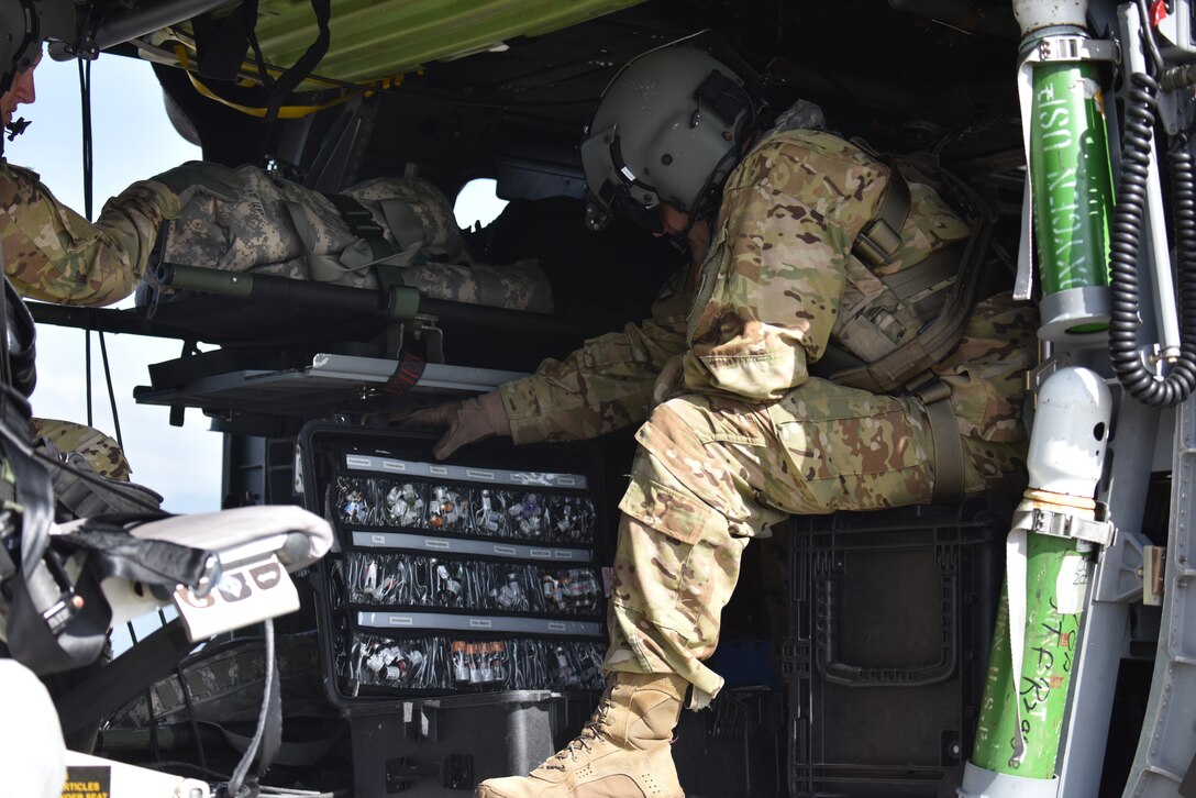 U.S. Army Chief Warrant Officer 3 James Ward, a critical care flight paramedic assigned to the 1st Battalion 228th Aviation Regiment Air Ambulance Detachment at Joint Task Force-Bravo, examines medical supplies that would be used in the event of a medical evacuation at Soto Cano Air Base, Honduras, July 31, 2020. The 1-228 Charlie Company aeromedical evacuation team recently conducted three lifesaving aeromedical evacuations in four weeks. The missions represented one of the first times the pilots and crew departed the base using N-95 masks to protect themselves from the coronavirus.