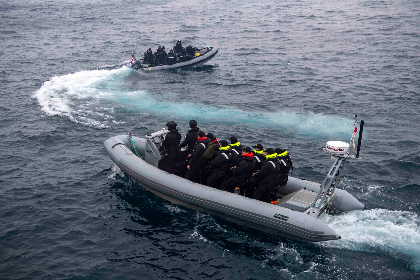 Royal Canadian Navy Sailors travel via small boat to the Arleigh Burke-class guided-missile destroyer USS Thomas Hudner (DDG 116) during a cross-deck evolution involving Thomas Hudner and Royal Canadian Navy ships Kingston-class coastal defense vessel HMCS Glace Bay (MM 701), the Halifax-class frigate HMCS Ville de Quebec (FFH 332) and the Canadian commercial container ship MV Asterix.