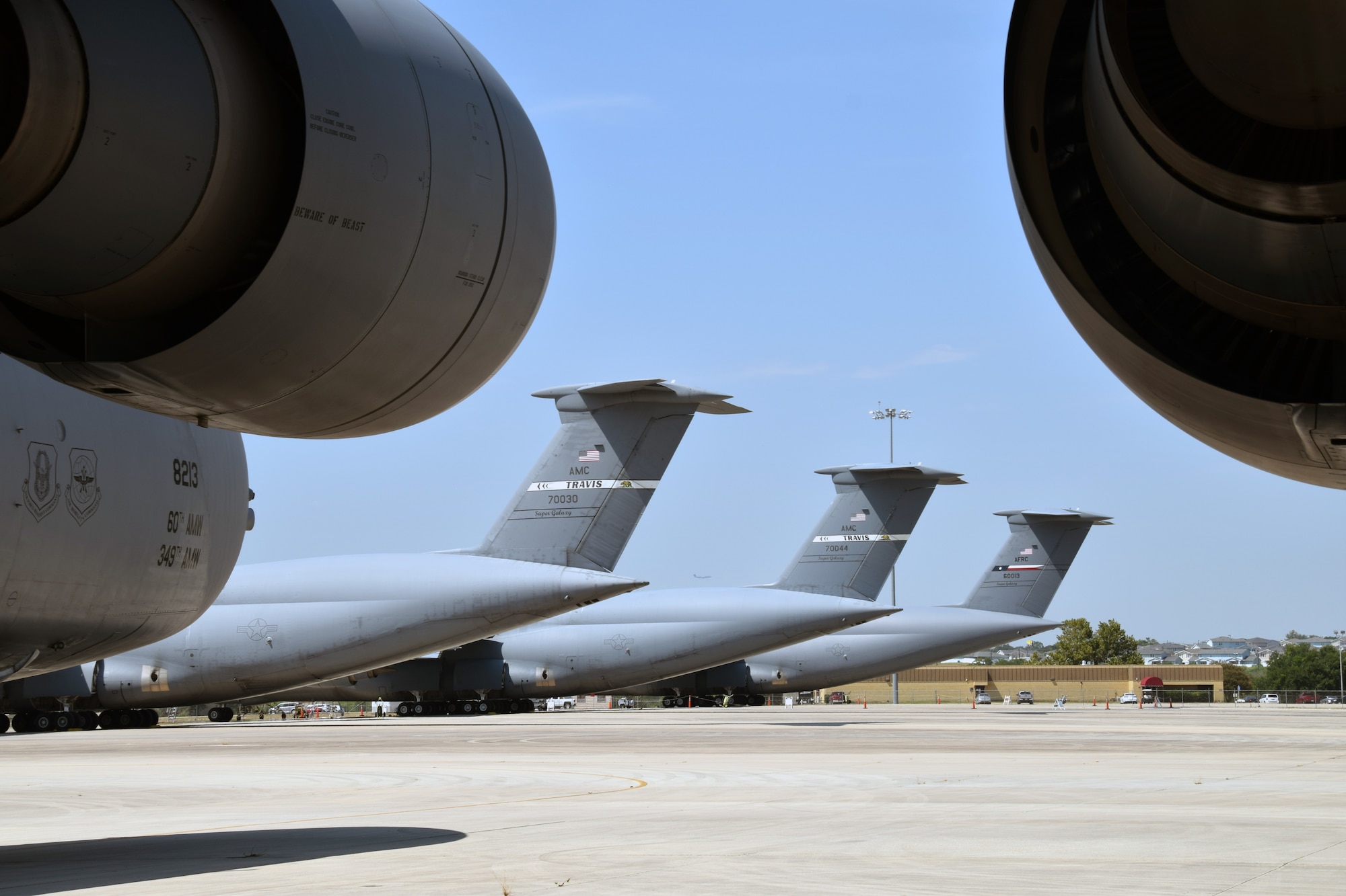 C-5M Super Galaxy cargo aircraft assigned to Travis Air Force Base, California, sit among C-5Ms with the 433rd Airlift Wing on a ramp Aug. 20 at Joint Base San Antonio-Lackland, Texas.