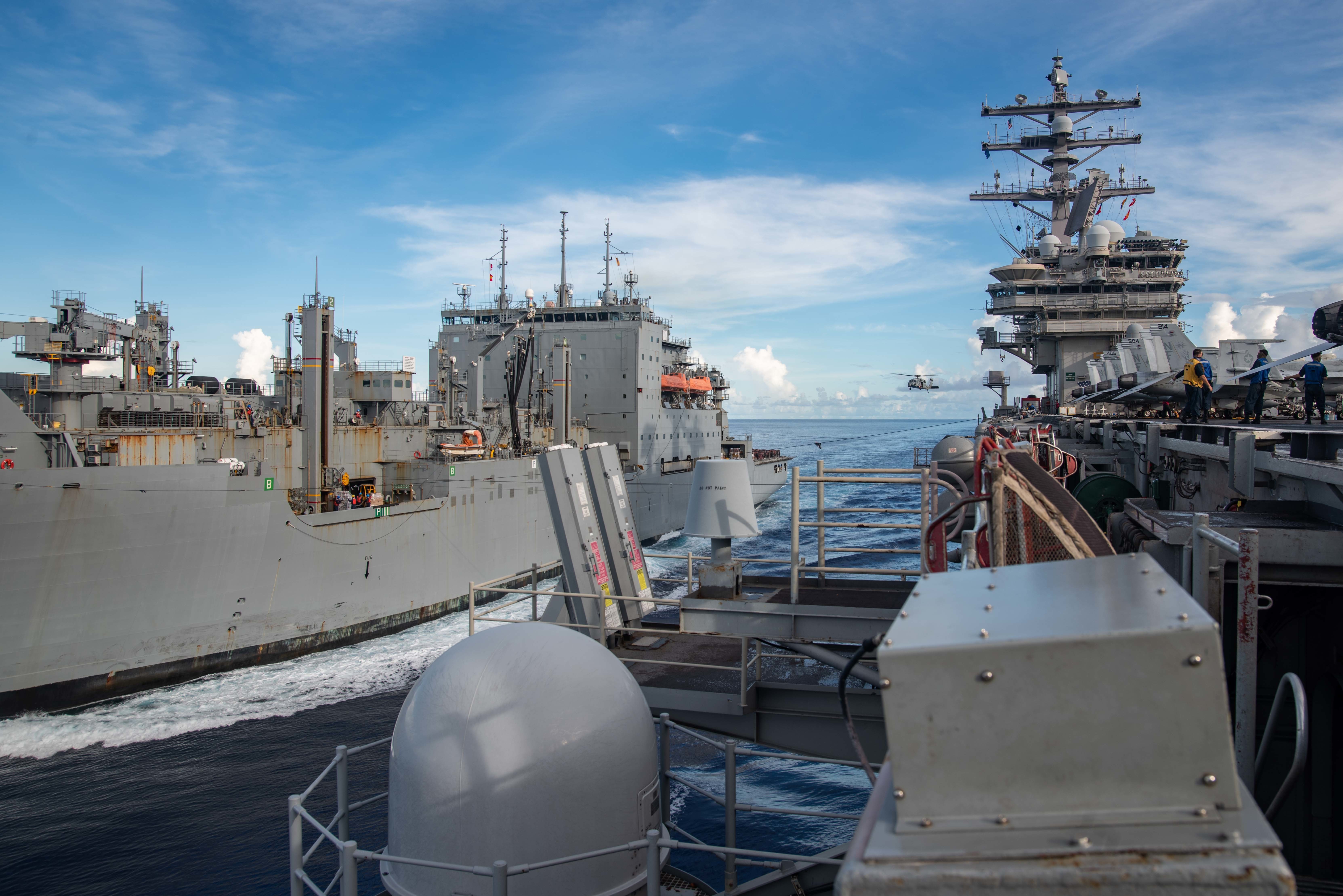 The dry cargo and ammunition ship USNS Cesar Chavez (T-AKE 14) steams alongside the Navy’s only forward-deployed aircraft carrier USS Ronald Reagan (CVN 76) during a replenishment-at-sea.