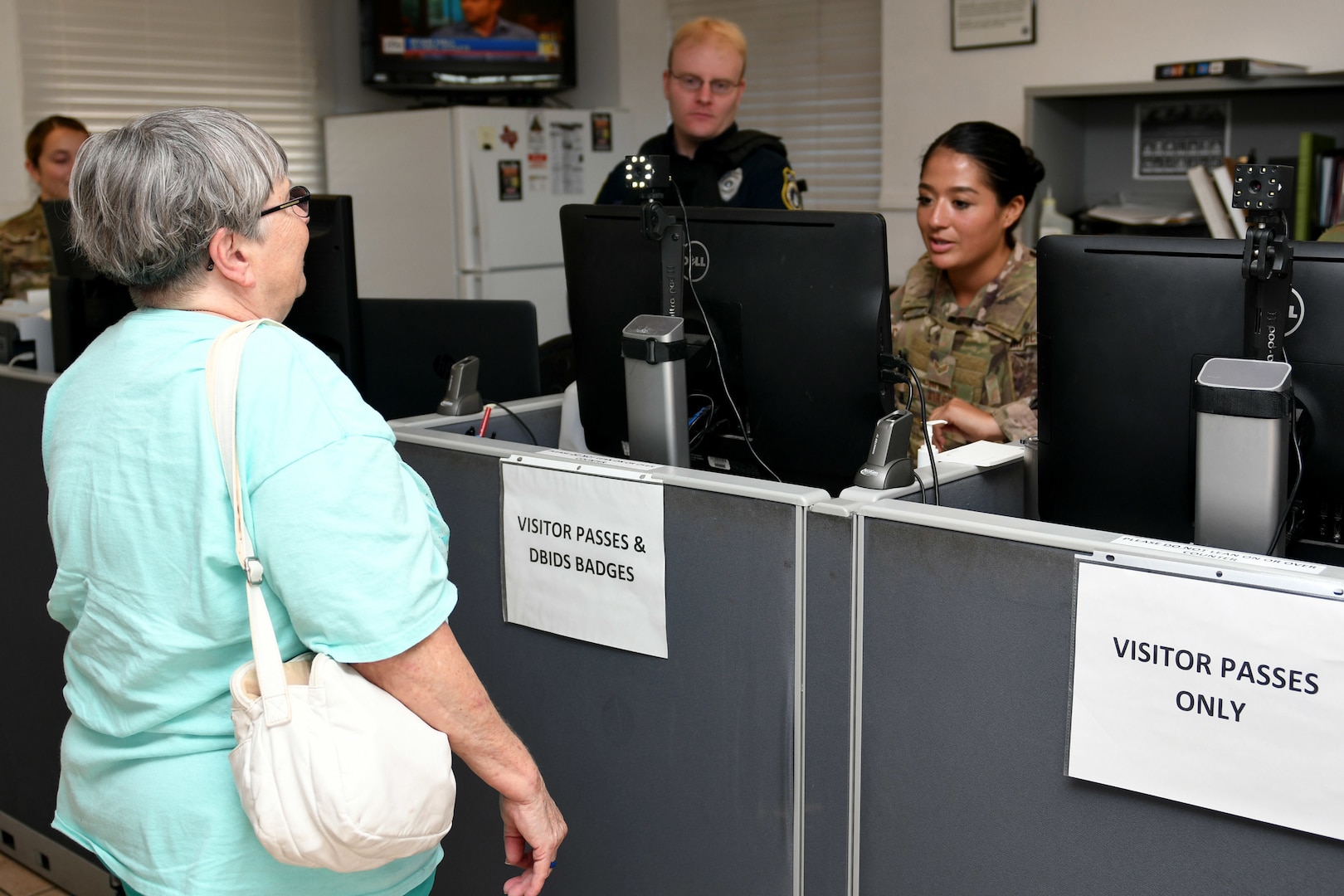 A woman poses for an ID card photo.