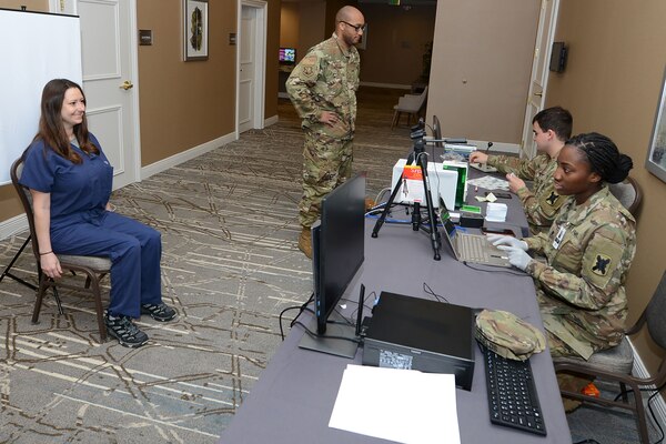 Soldiers create ID cards.