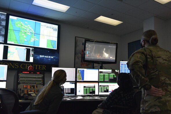 Jessica Williams, 45th Weather Squadron launch weather officer, Arlena Moses, 45th Weather Squadron launch weather officer, and Maj. Janelle Jenniges, 45th Weather Squadron director of operations look at weather data prior to the launch of Falcon 9 Starlink L-8 at Cape Canaveral Air Force Station, Fla., June 13, 2020. For the first time at CCAFS, an all-female weather team provided weather support for a launch.(U.S. Space Force photo by Senior Airman Dalton Williams)