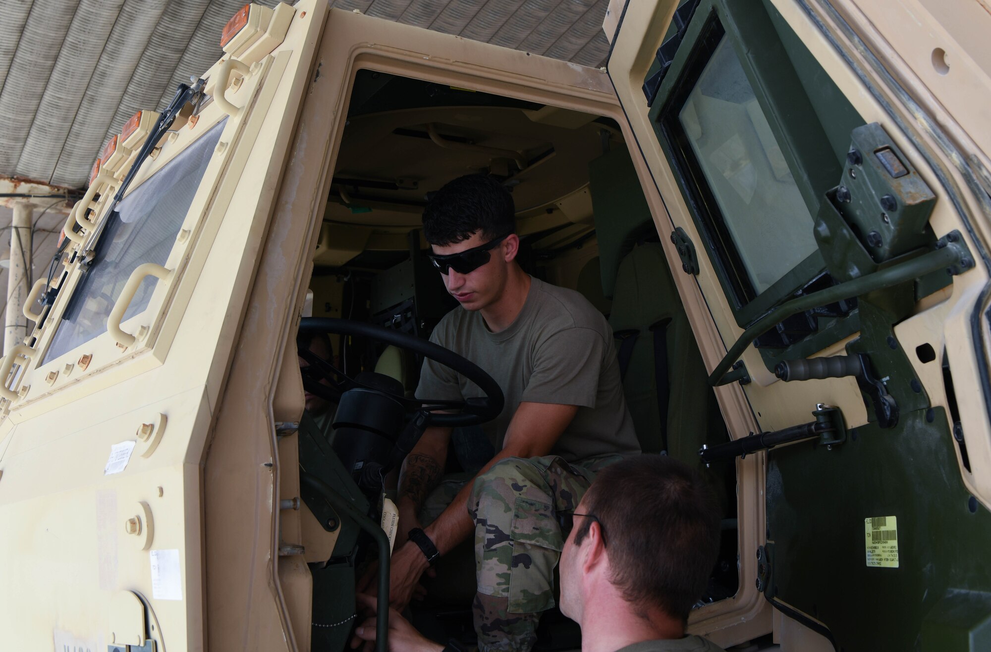 Air Force Senior Airman Cody Rightnowar, 380th Expeditionary Logistics Readiness Squadron ground transportation apprentice, learns about steering wheel controls of the M1083A1P2, Long Term Armor Strategy (LTAS) Five Ton Cargo Truck, July 22, 2020, at Al Dhafra Air Base, United Arab Emirates.