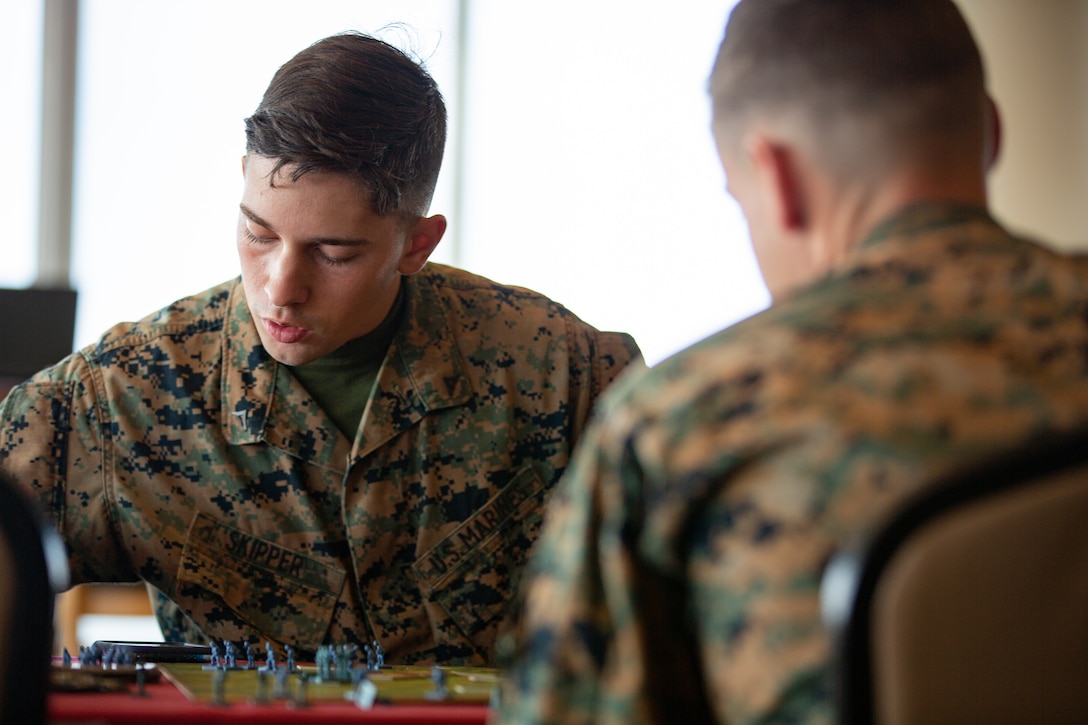 U.S. Marines check game rules during a game of Memoir 44’ on Camp Schwab, Okinawa, Japan, Dec. 10.