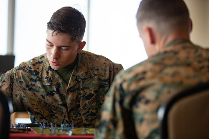 U.S. Marines check game rules during a game of Memoir 44’ on Camp Schwab, Okinawa, Japan, Dec. 10.