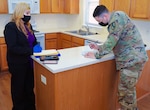 A newly assigned drill sergeant with the 199th Infantry Brigade approves a move-in inspection form at his new home on Fort Benning, Georgia, June 25, 2020.