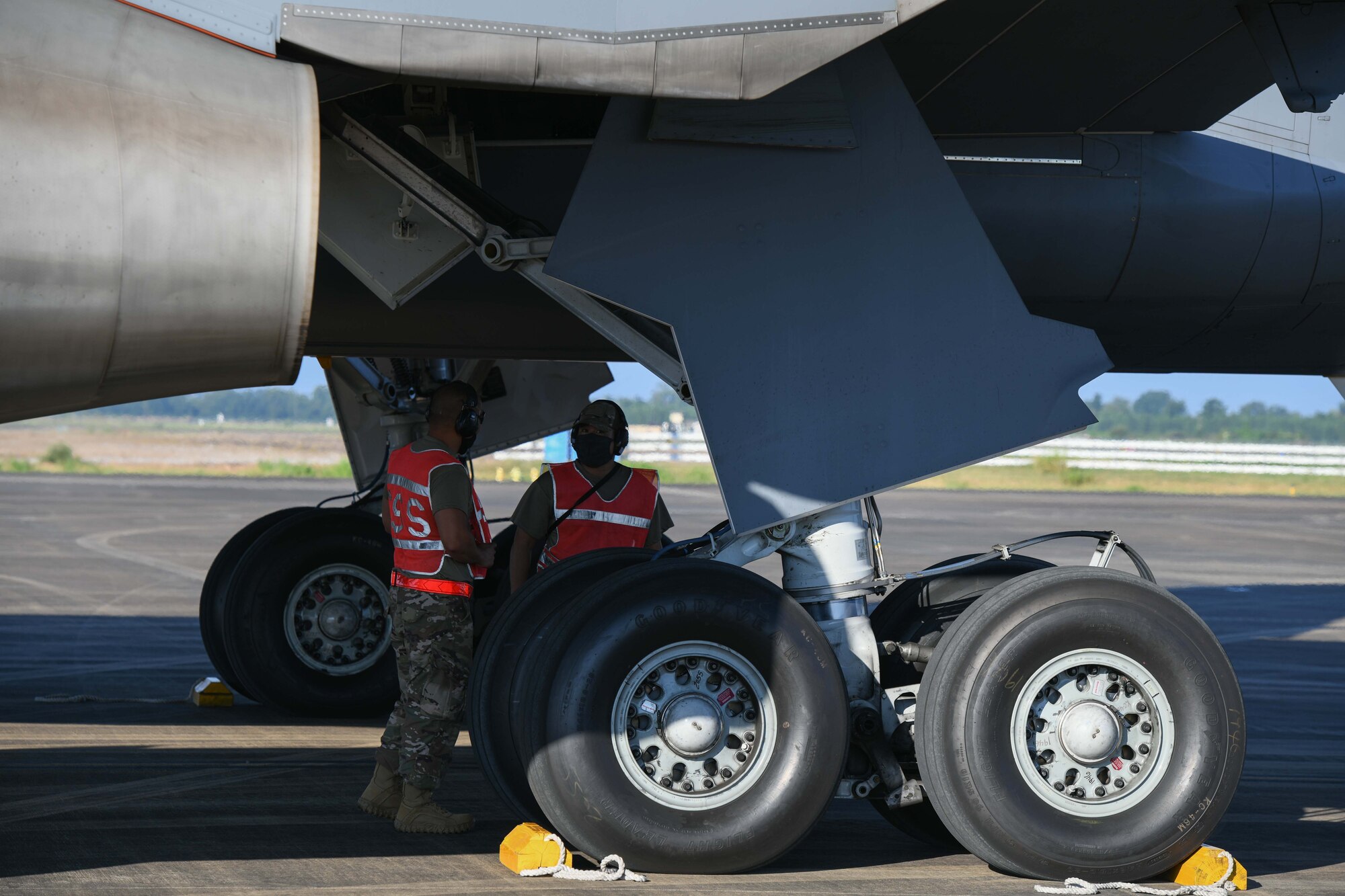 Airmen inspect a tire